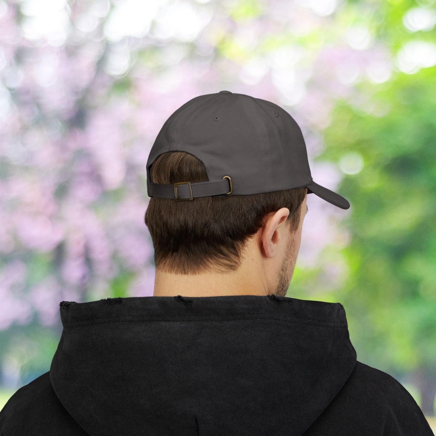 Back of gray classic baseball hat with adjustable strap.
