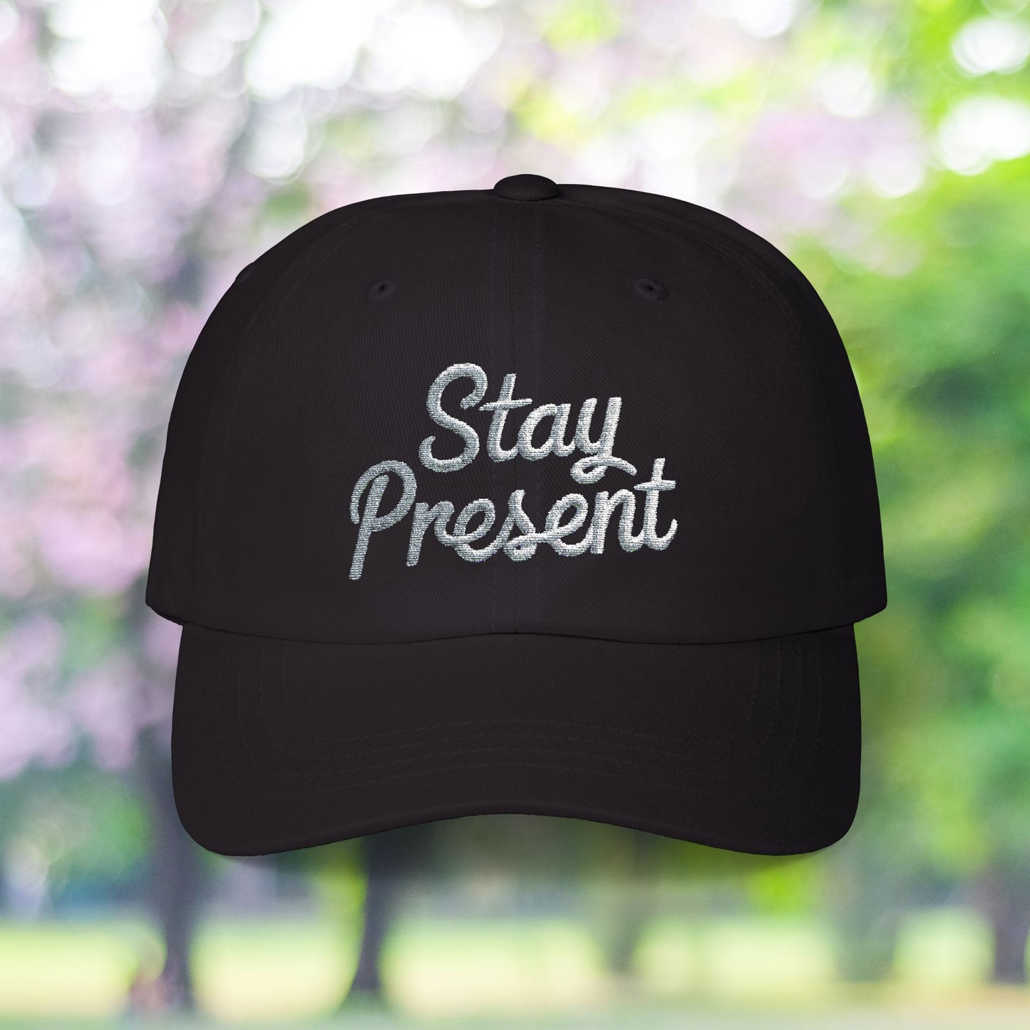 Black vintage style cap with 'Stay Present' embroidery.