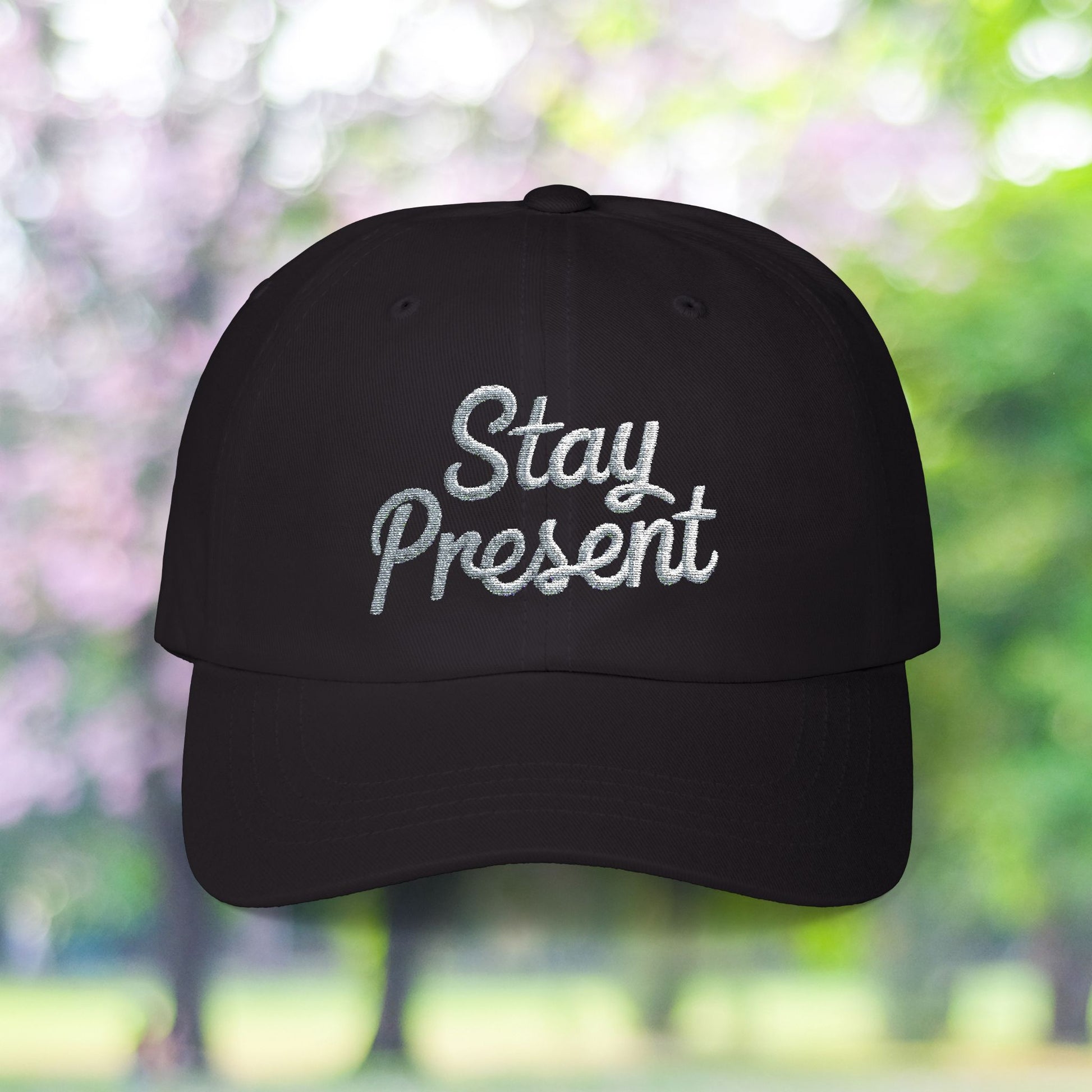 Black vintage style cap with 'Stay Present' embroidery.