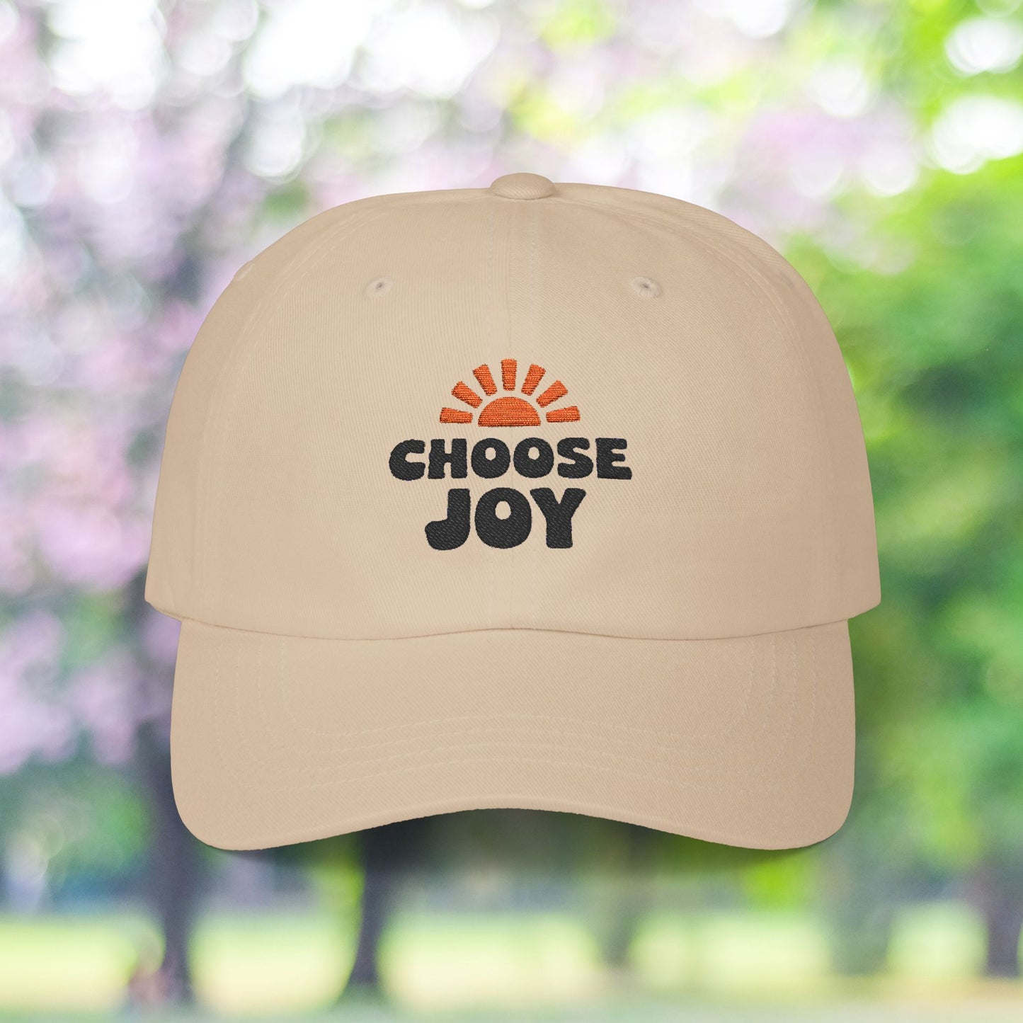 Beige dad hat with "Choose Joy" sun burst graphic.